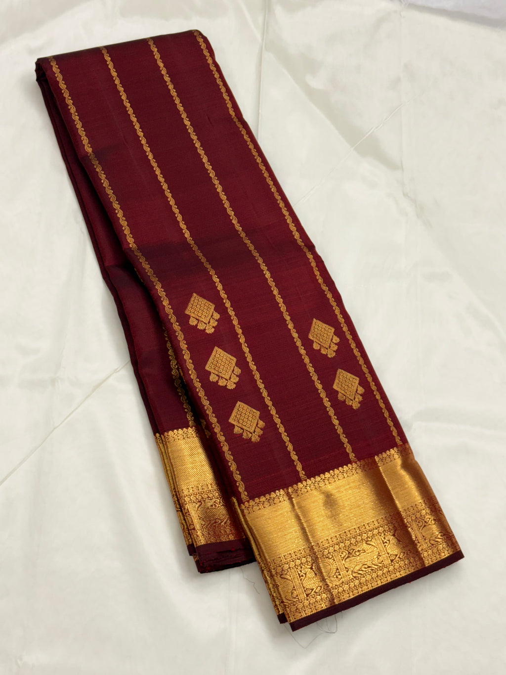 Maroon kanchipuram silk saree with veldhari weaving